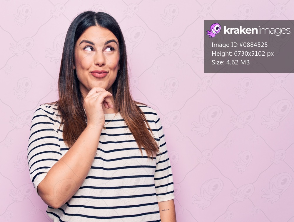 Young beautiful brunette woman wearing casual striped t-shirt over isolated pink background thinking concentrated about doubt with finger on chin and looking up wondering