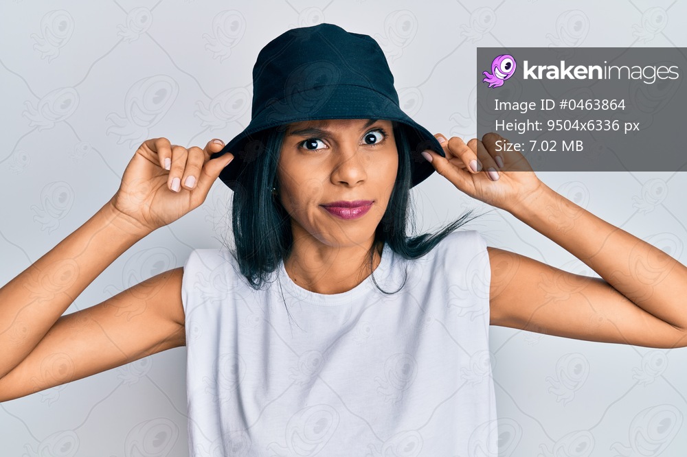 Young african american woman wearing fashion hat skeptic and nervous, frowning upset because of problem. negative person. 