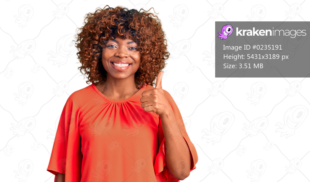 Young african american woman wearing casual clothes doing happy thumbs up gesture with hand. approving expression looking at the camera showing success. 