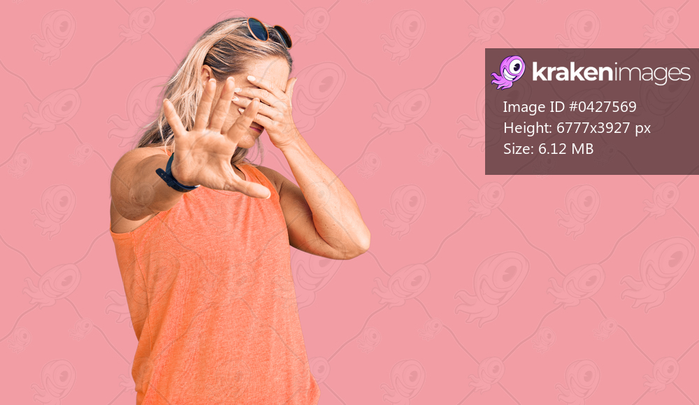 Middle age fit blonde woman wearing casual summer clothes and sunglasses covering eyes with hands and doing stop gesture with sad and fear expression. embarrassed and negative concept. 