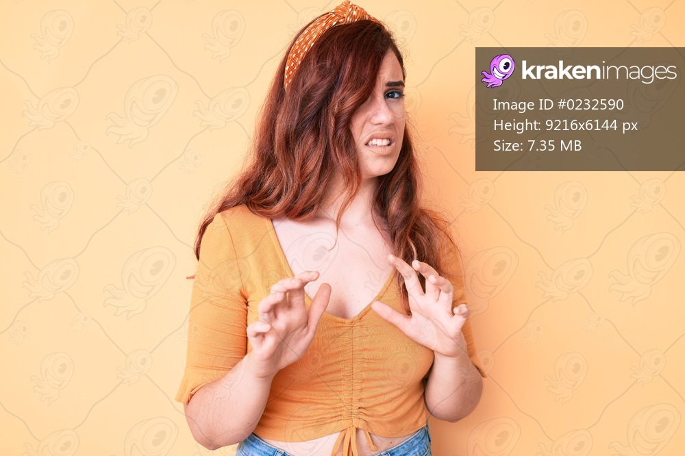 Young beautiful woman wearing casual clothes disgusted expression, displeased and fearful doing disgust face because aversion reaction. with hands raised 