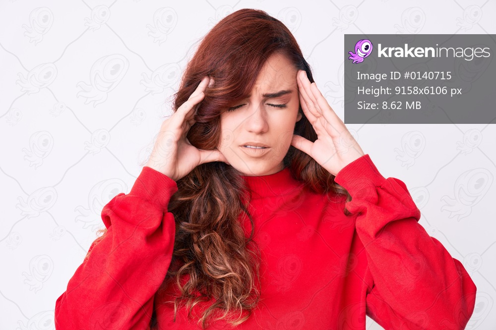 Young beautiful woman wearing casual clothes with hand on head for pain in head because stress. suffering migraine. 