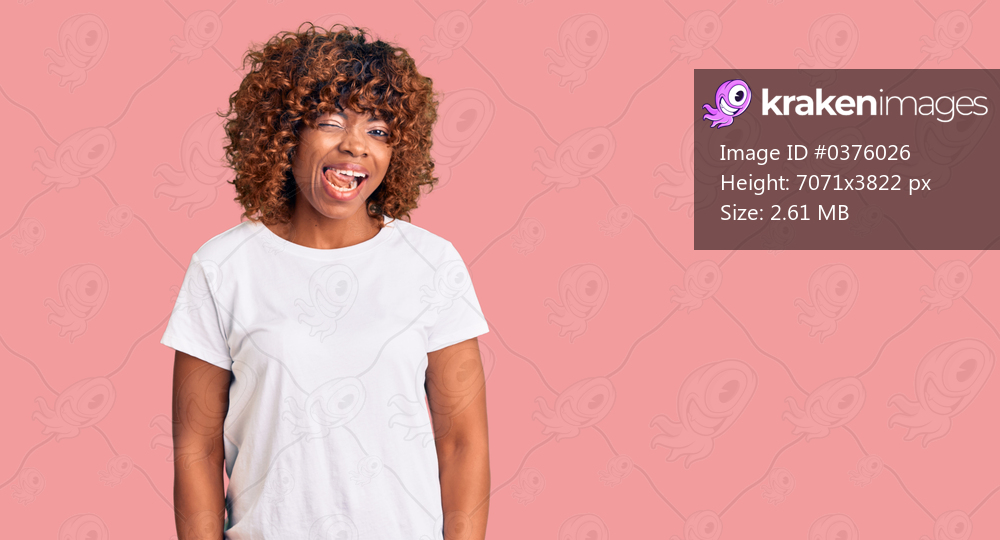 Young african american woman wearing casual white tshirt winking looking at the camera with sexy expression, cheerful and happy face. 