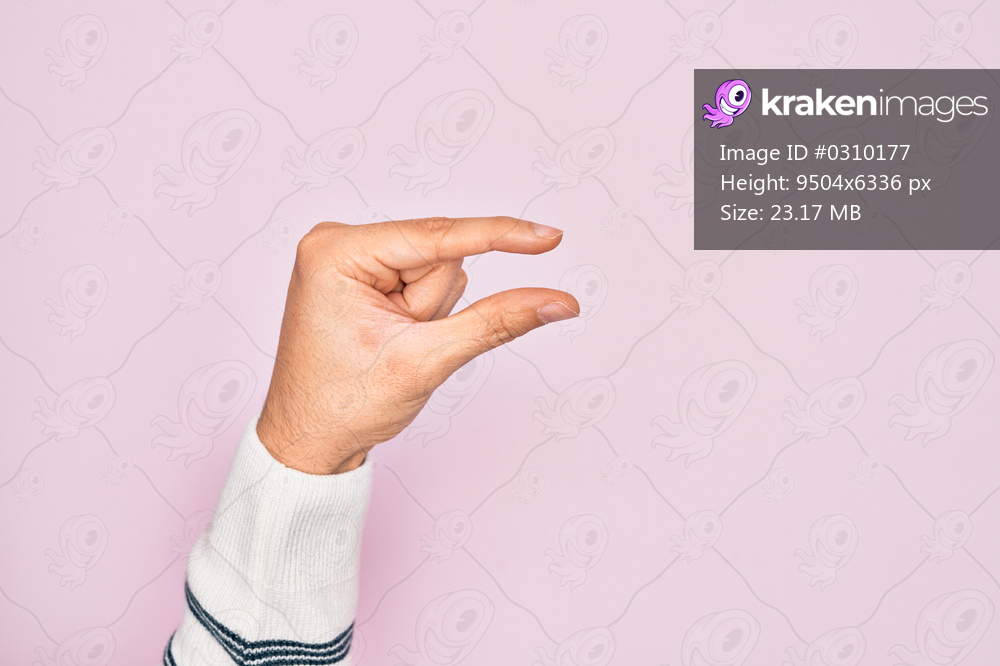 Hand of caucasian young man showing fingers over isolated pink background picking and taking invisible thing, holding object with fingers showing space