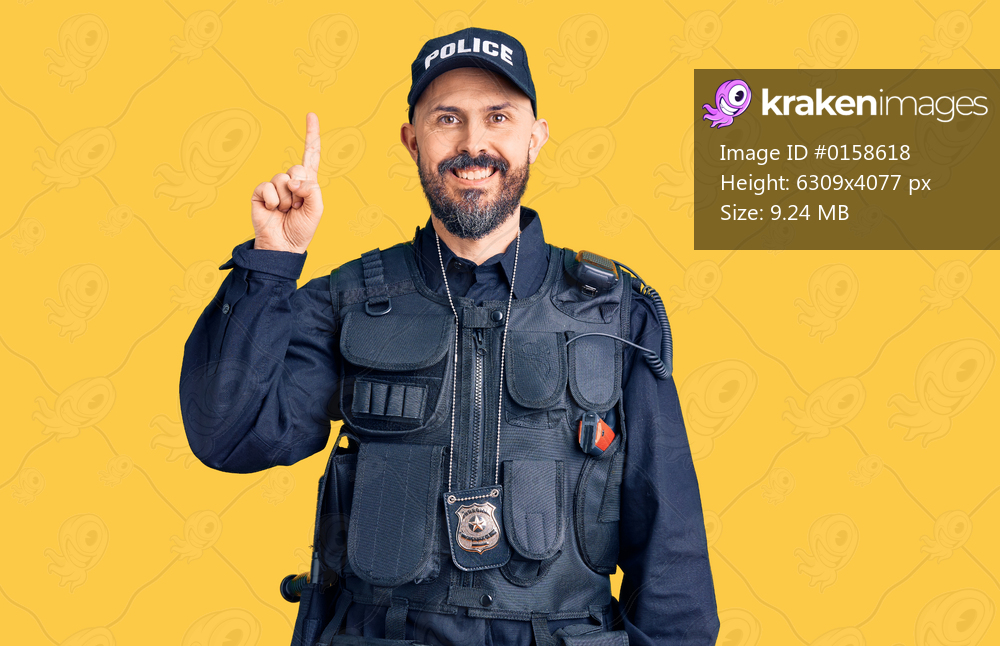 Young handsome man wearing police uniform showing and pointing up with finger number one while smiling confident and happy. 