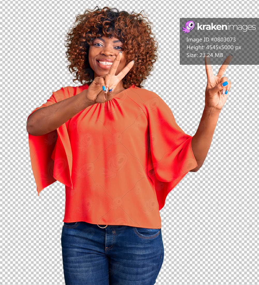 Young african american woman wearing casual clothes smiling looking to the camera showing fingers doing victory sign. number two.