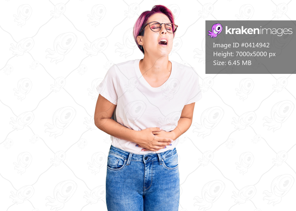 Young beautiful woman with pink hair wearing casual clothes and glasses with hand on stomach because nausea, painful disease feeling unwell. ache concept. 
