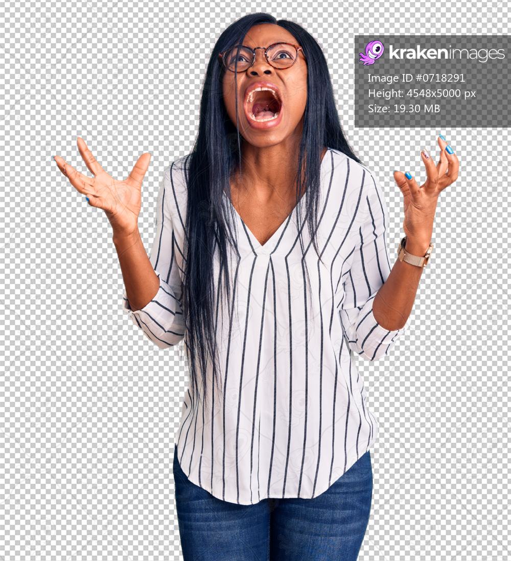 Young african american woman wearing casual clothes and glasses crazy and mad shouting and yelling with aggressive expression and arms raised. frustration concept.