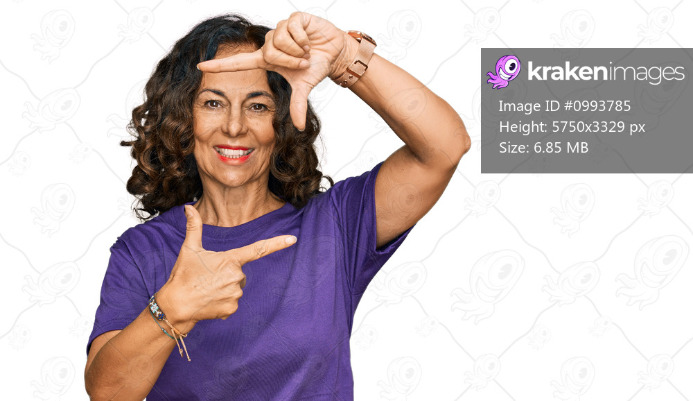 Middle age hispanic woman wearing casual clothes smiling making frame with hands and fingers with happy face. creativity and photography concept. 