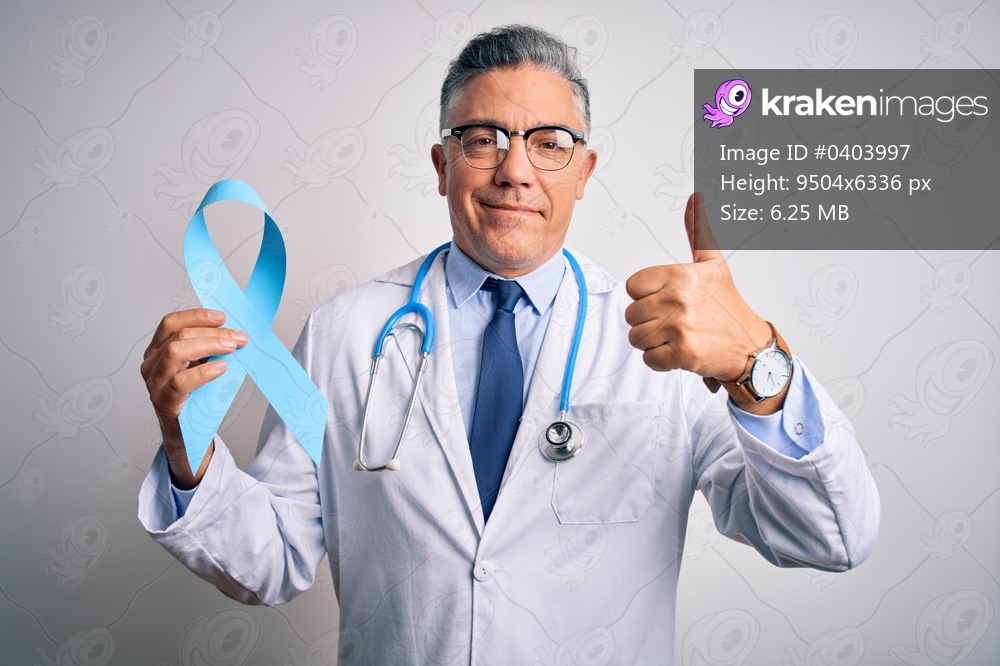 Middle age handsome grey-haired doctor man wearing coat holding blue cancer ribbon happy with big smile doing ok sign, thumb up with fingers, excellent sign