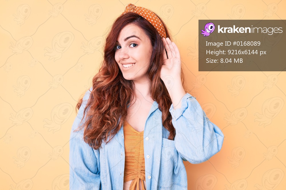 Young beautiful woman wearing casual clothes smiling with hand over ear listening and hearing to rumor or gossip. deafness concept. 
