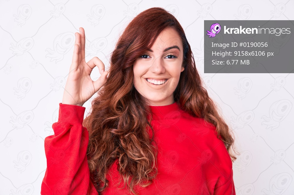 Young beautiful woman wearing casual clothes smiling positive doing ok sign with hand and fingers. successful expression. 