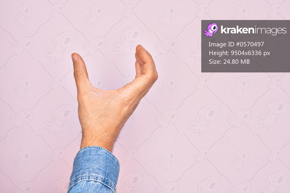 Hand of caucasian young man showing fingers over isolated pink background picking and taking invisible thing, holding object with fingers showing space