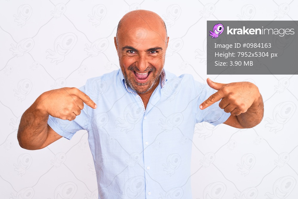 Middle age handsome man wearing casual shirt standing over isolated white background looking confident with smile on face, pointing oneself with fingers proud and happy.