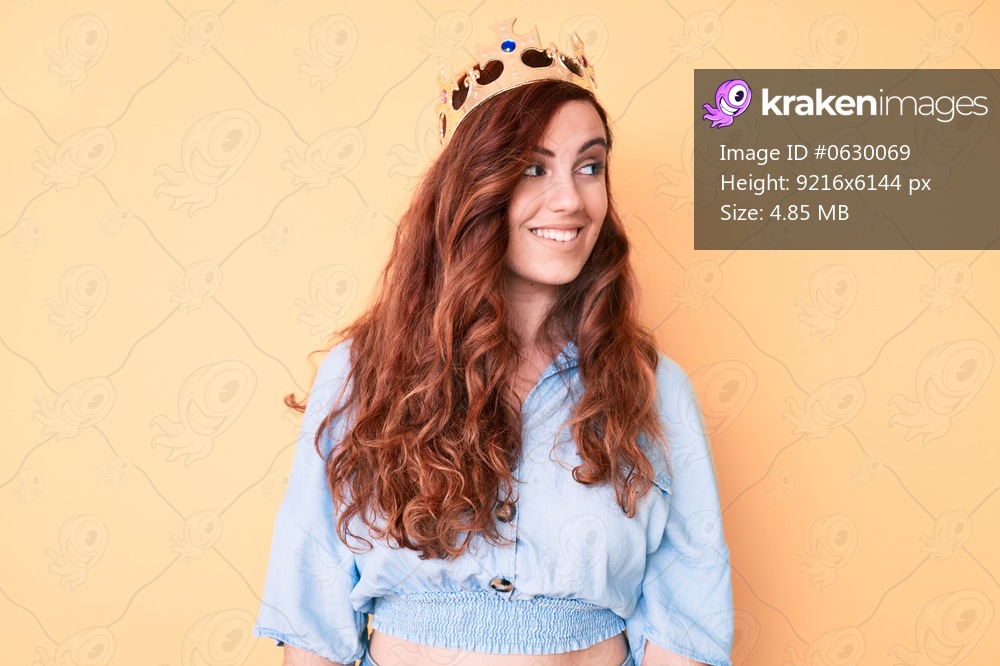 Young beautiful woman wearing princess crown looking to side, relax profile pose with natural face and confident smile. 