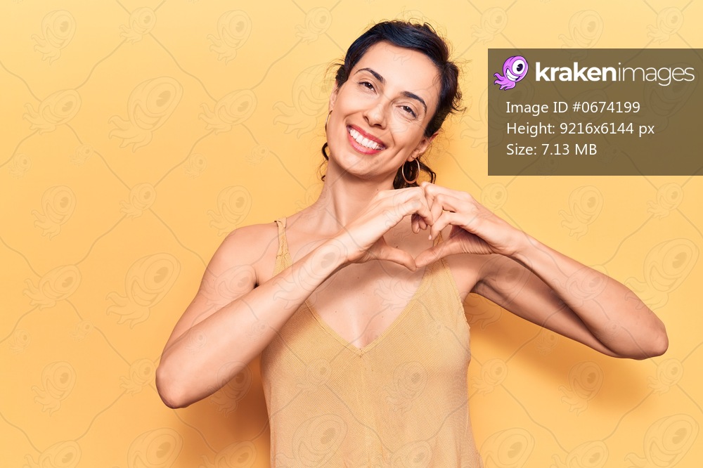 Young beautiful hispanic woman wearing casual clothes smiling in love showing heart symbol and shape with hands. romantic concept. 
