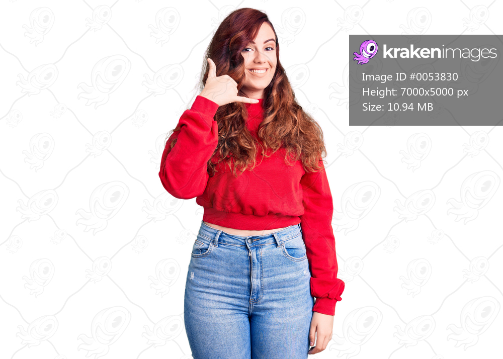 Young beautiful woman wearing casual winter sweater smiling doing phone gesture with hand and fingers like talking on the telephone. communicating concepts. 
