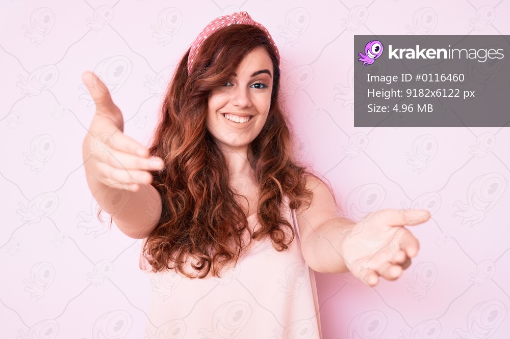 Young beautiful woman wearing casual clothes looking at the camera smiling with open arms for hug. cheerful expression embracing happiness. 