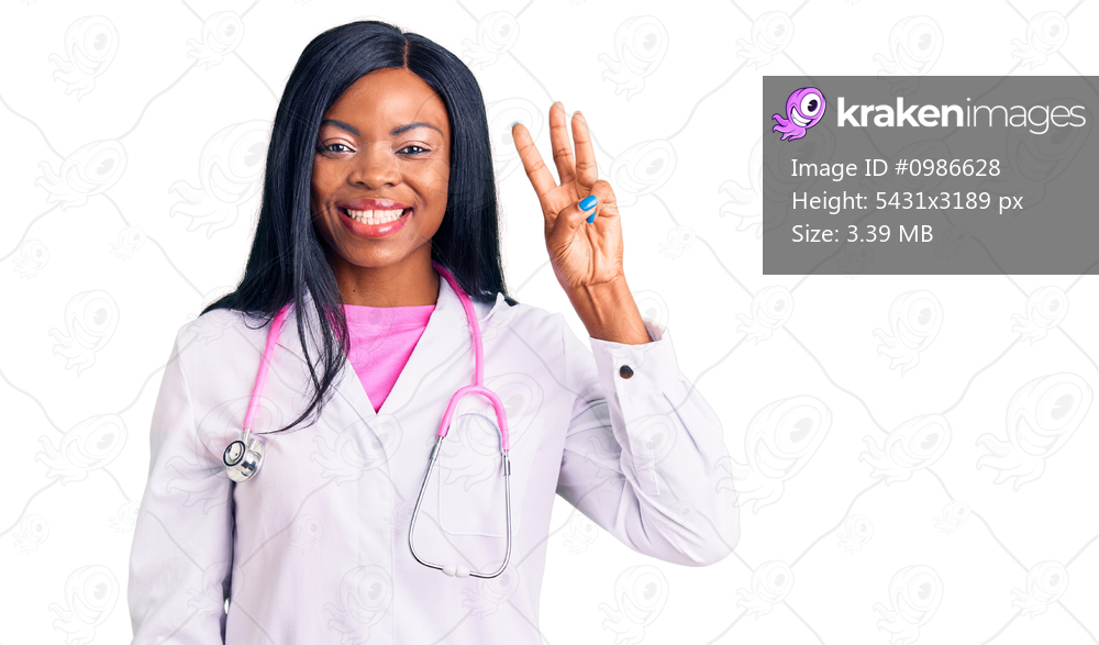 Young african american woman wearing doctor stethoscope showing and pointing up with fingers number three while smiling confident and happy. 