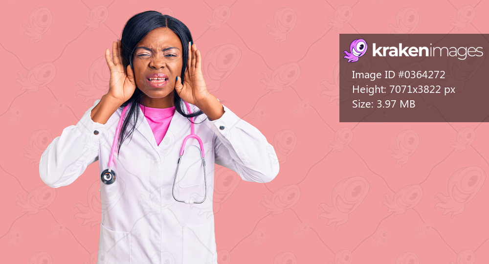 Young african american woman wearing doctor stethoscope trying to hear both hands on ear gesture, curious for gossip. hearing problem, deaf 