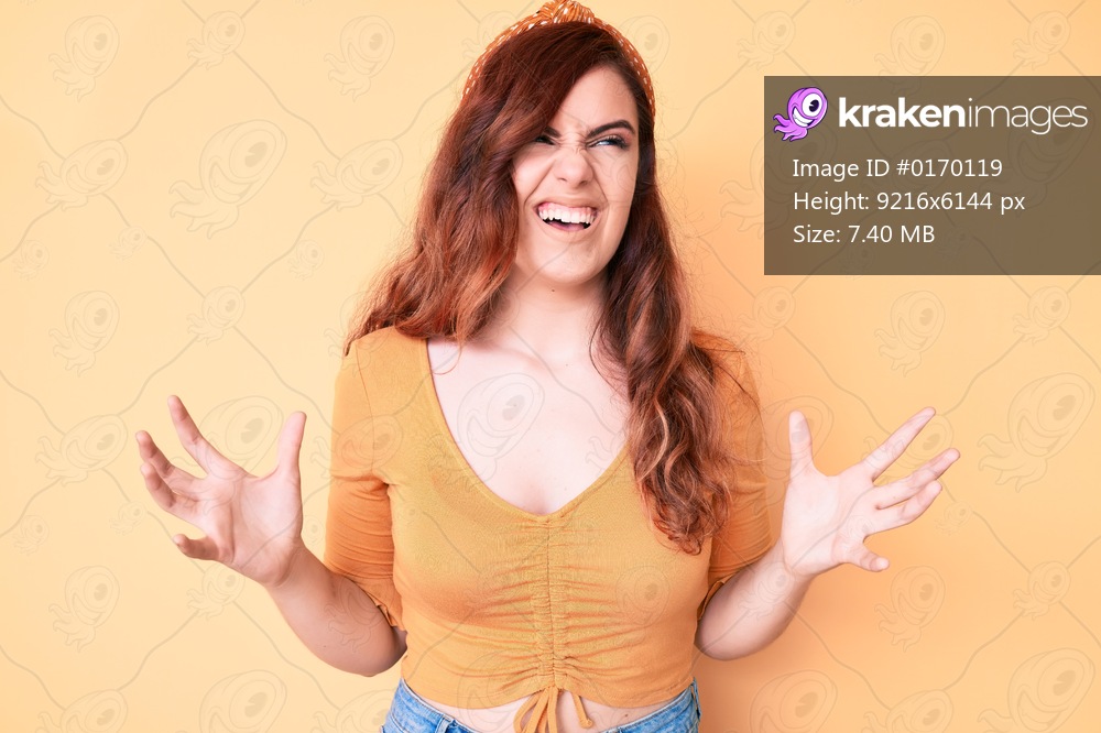 Young beautiful woman wearing casual clothes crazy and mad shouting and yelling with aggressive expression and arms raised. frustration concept. 