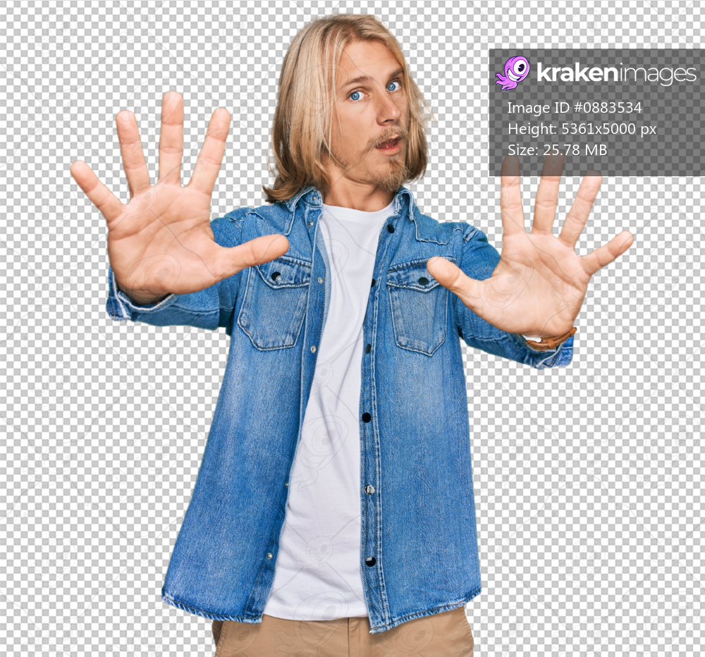 Caucasian man with blond long hair wearing casual denim jacket doing stop gesture with hands palms, angry and frustration expression