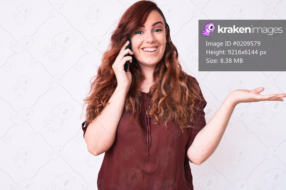 Young beautiful woman having conversation talking on the smartphone celebrating victory with happy smile and winner expression with raised hands 