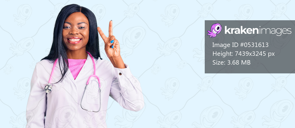 Young african american woman wearing doctor stethoscope showing and pointing up with fingers number two while smiling confident and happy. 