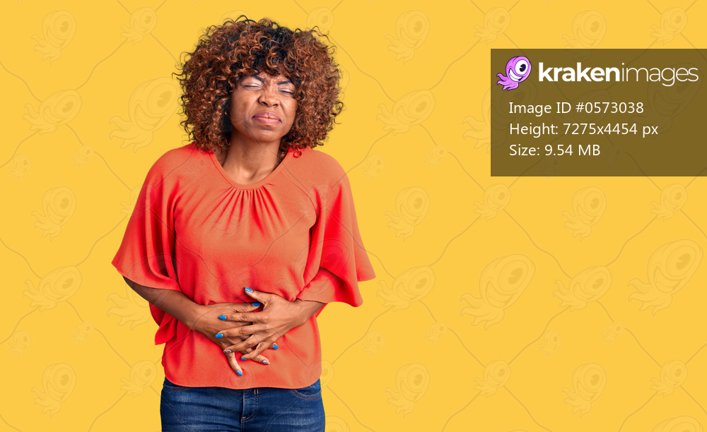 Young african american woman wearing casual clothes with hand on stomach because indigestion, painful illness feeling unwell. ache concept. 