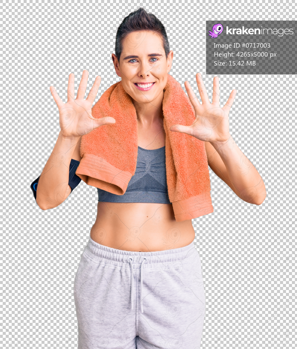Young woman with short hair wearing sportswear and towel using smartphone showing and pointing up with fingers number ten while smiling confident and happy.