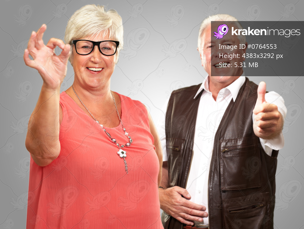 Happy Senior Couple Isolated On Gray Background