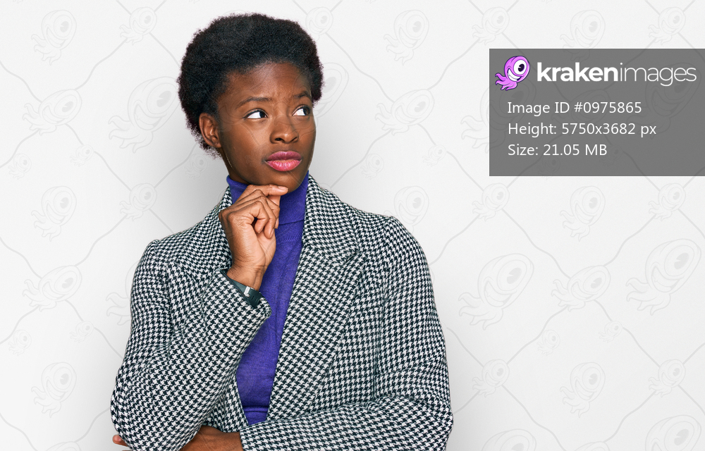Young african american girl wearing casual clothes with hand on chin thinking about question, pensive expression. smiling with thoughtful face. doubt concept. 