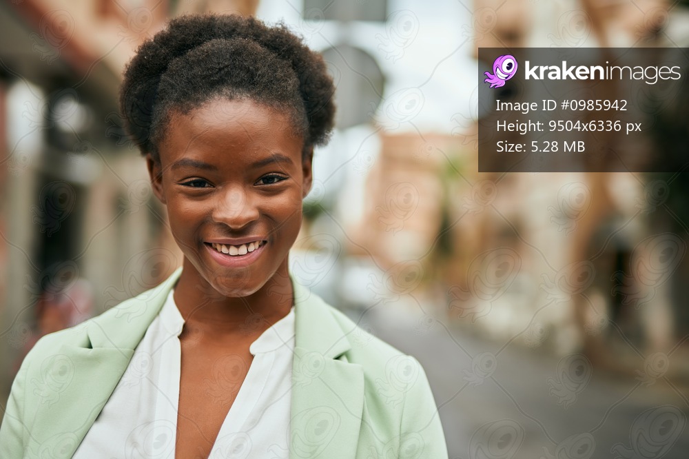 Young african american businesswoman smiling happy standing at the city