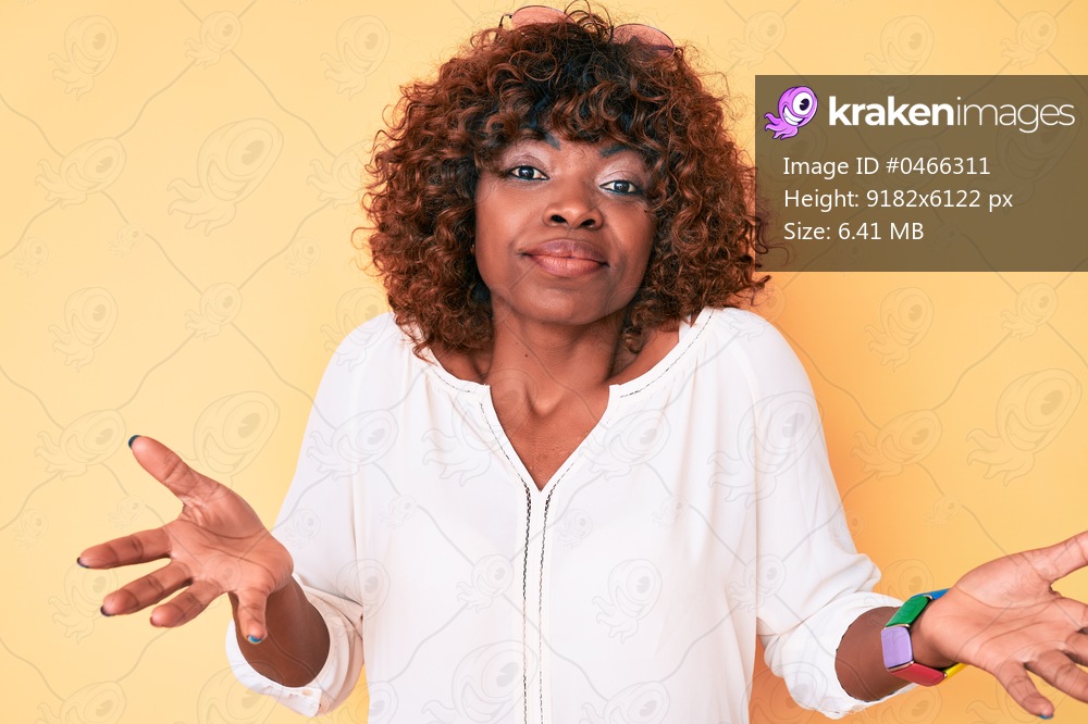 Young african american woman wearing casual clothes clueless and confused expression with arms and hands raised. doubt concept. 