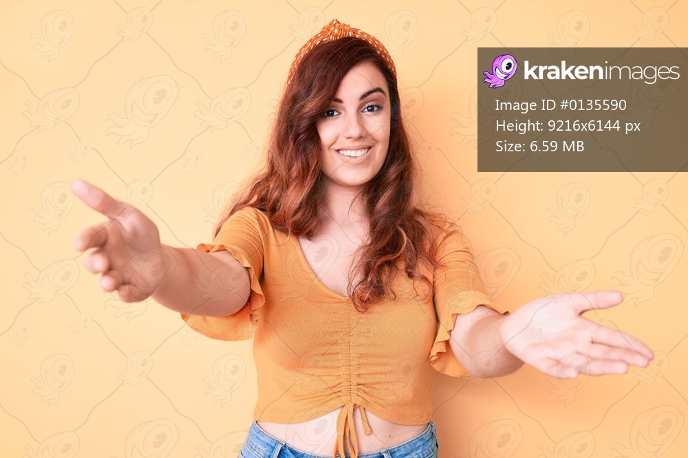 Young beautiful woman wearing casual clothes looking at the camera smiling with open arms for hug. cheerful expression embracing happiness. 