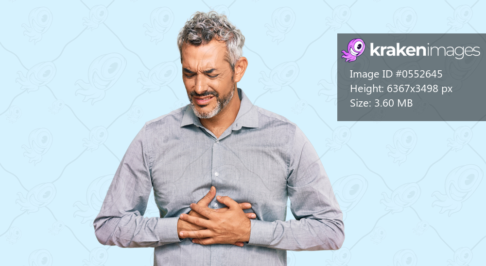 Middle age grey-haired man wearing casual clothes with hand on stomach because indigestion, painful illness feeling unwell. ache concept. 
