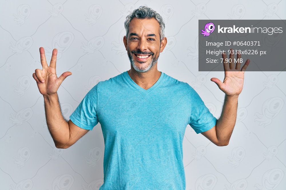 Middle age grey-haired man wearing casual clothes showing and pointing up with fingers number eight while smiling confident and happy. 