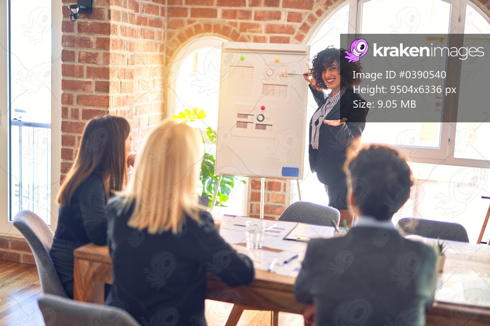 Group of business workers working together in a meeting. One of them making presentation to colleagues at the office
