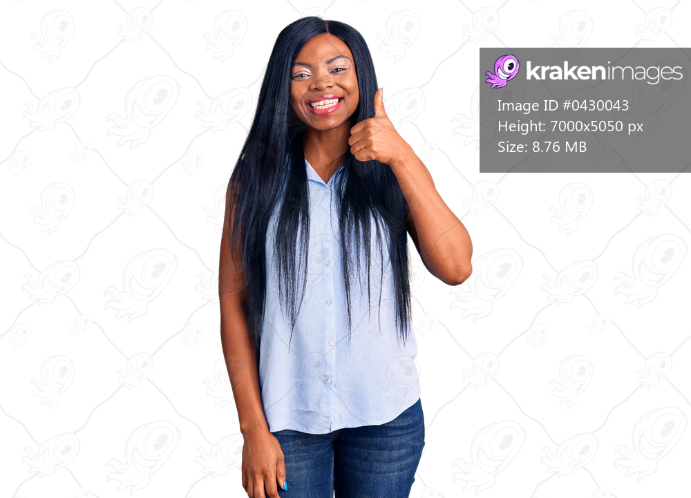 Young african american woman wearing casual clothes doing happy thumbs up gesture with hand. approving expression looking at the camera showing success. 