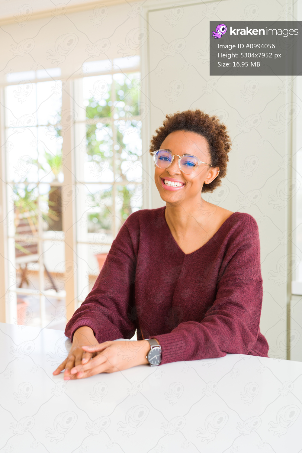 Beautiful young african woman with afro hair wearing glasses