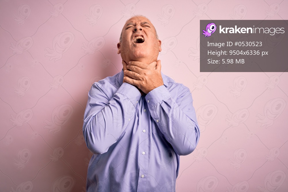 Middle age handsome hoary man wearing casual shirt standing over pink background shouting and suffocate because painful strangle. Health problem. Asphyxiate and suicide concept.