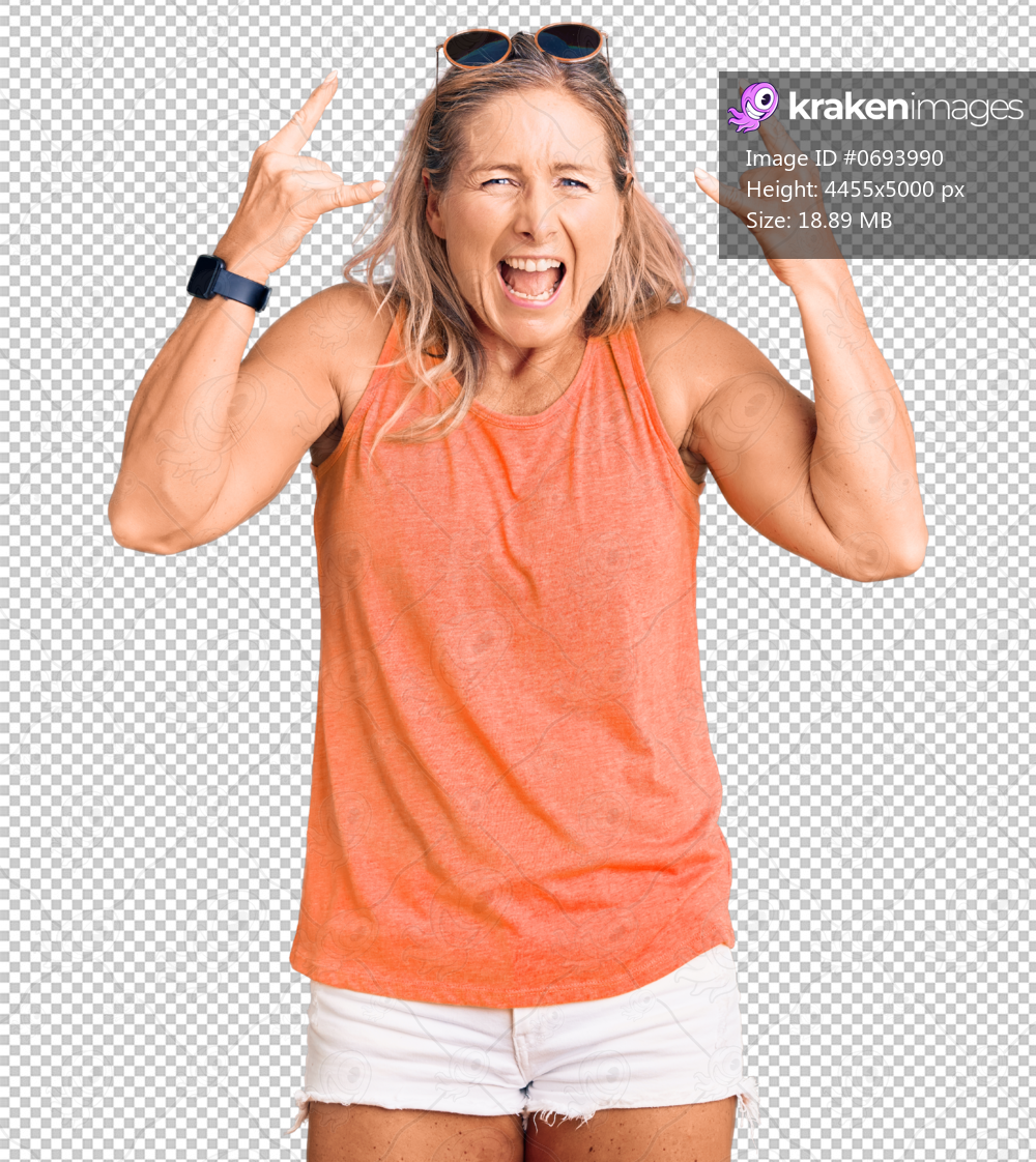 Middle age fit blonde woman wearing casual summer clothes and sunglasses shouting with crazy expression doing rock symbol with hands up. music star. heavy music concept.