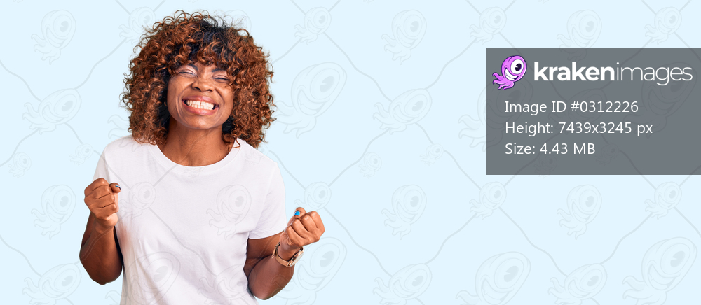 Young african american woman wearing casual white tshirt very happy and excited doing winner gesture with arms raised, smiling and screaming for success. celebration concept. 