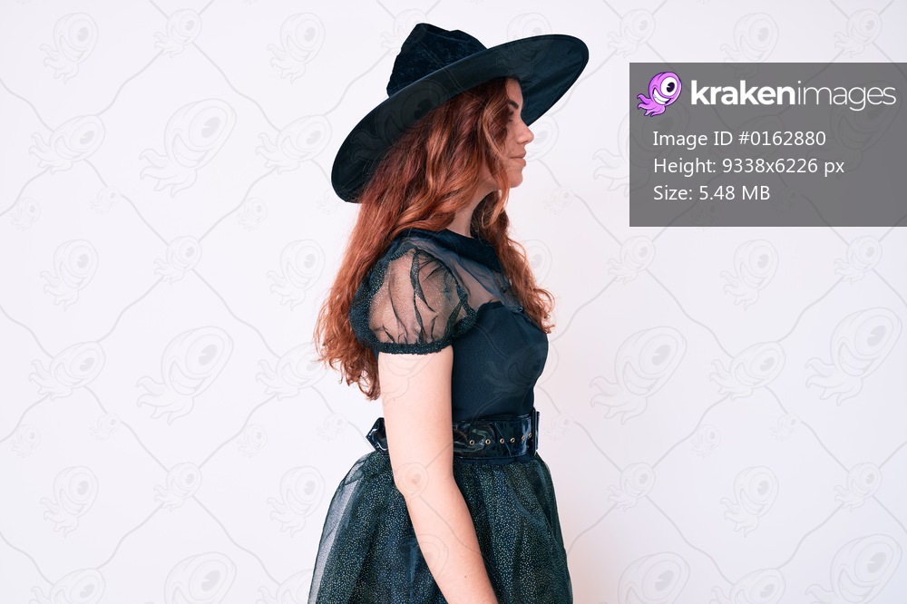 Young beautiful woman wearing witch halloween costume looking to side, relax profile pose with natural face and confident smile. 