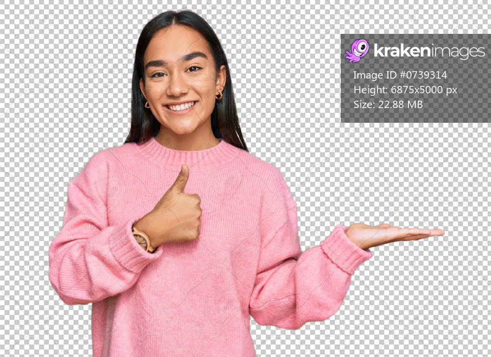 Young asian woman wearing casual winter sweater showing palm hand and doing ok gesture with thumbs up, smiling happy and cheerful