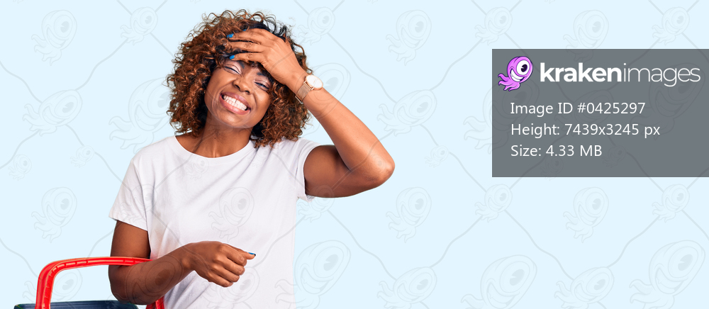 Young african american woman holding supermarket shopping basket stressed and frustrated with hand on head, surprised and angry face 