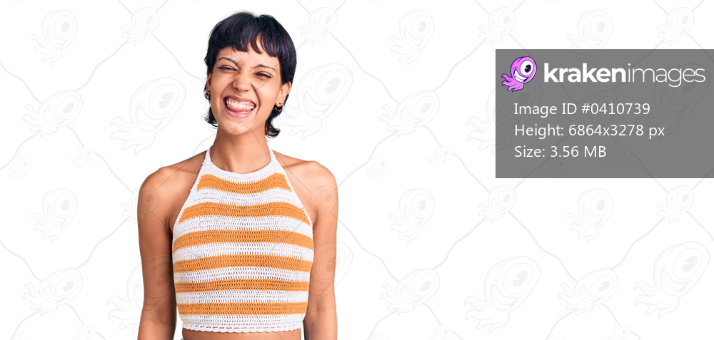 Young brunette woman with short hair wearing casual clothes sticking tongue out happy with funny expression. emotion concept. 