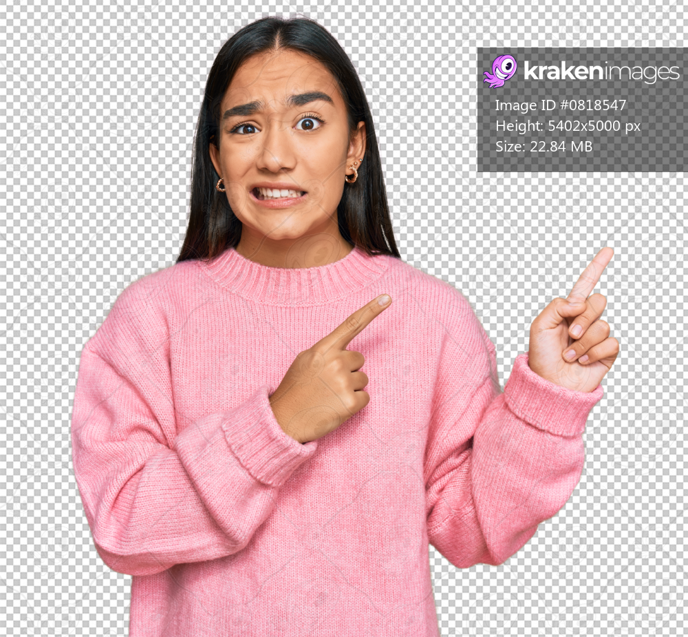 Young asian woman wearing casual winter sweater pointing aside worried and nervous with both hands, concerned and surprised expression