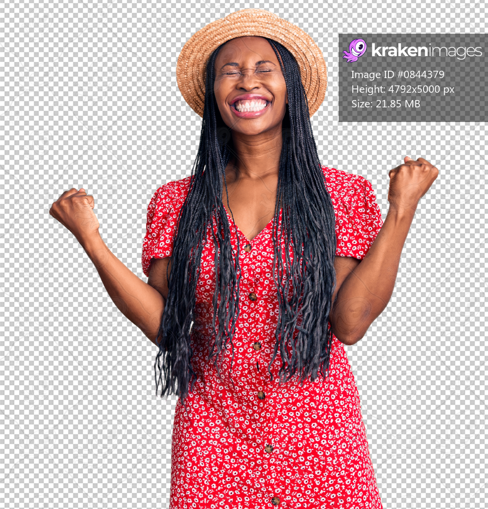 Young african american woman wearing summer hat very happy and excited doing winner gesture with arms raised, smiling and screaming for success. celebration concept.
