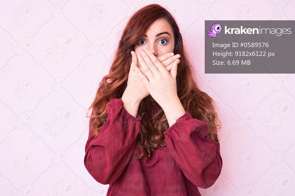 Young beautiful woman wearing casual winter sweater shocked covering mouth with hands for mistake. secret concept. 